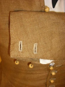 Closeup of buttonholes and buttons at the wrist