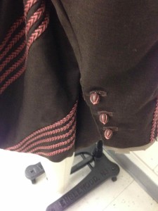 Sleeve end with hand-worked buttons