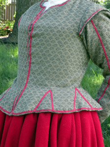 The sleeves are sewn into the armescye with a backstitch, the excess turned down and a sleeve lining of unbleached linen stitched over the raw edges. Seam allowances in garments of the time were narrower than they are today; 1/4 to 3/8 of an inch was common.