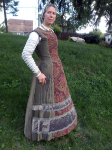 The Satin kirtle was made of charmeuse backed with canvas. If I was to do it again I'd go with true heavyweight silk satin; it prevents the wrinkles seen here at the side. The front section is brocade, and the guards are a layer of brown taffeta covered with a layer of metallic silk gold-and-purple gauze.